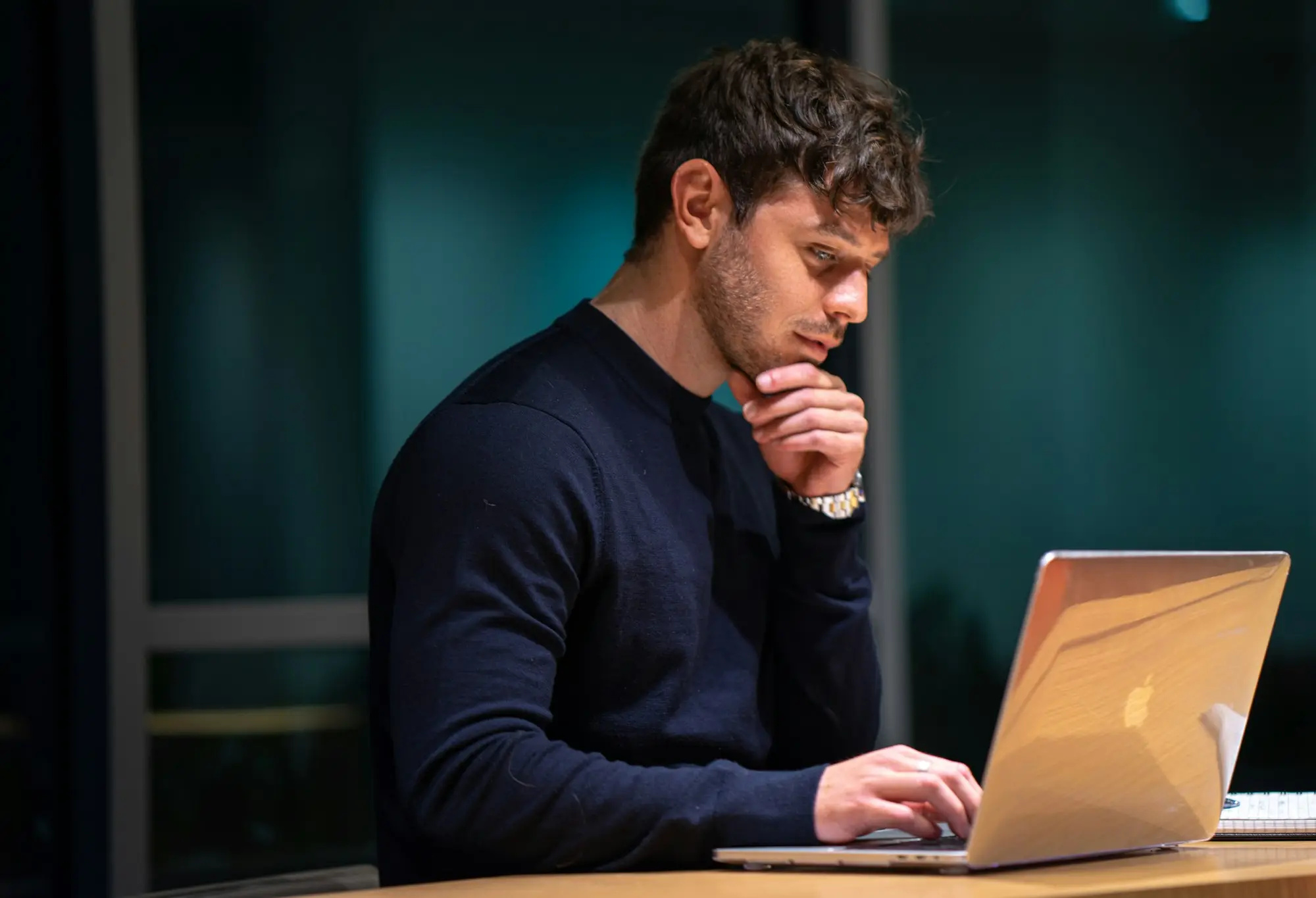 Man thinking in front of his laptop