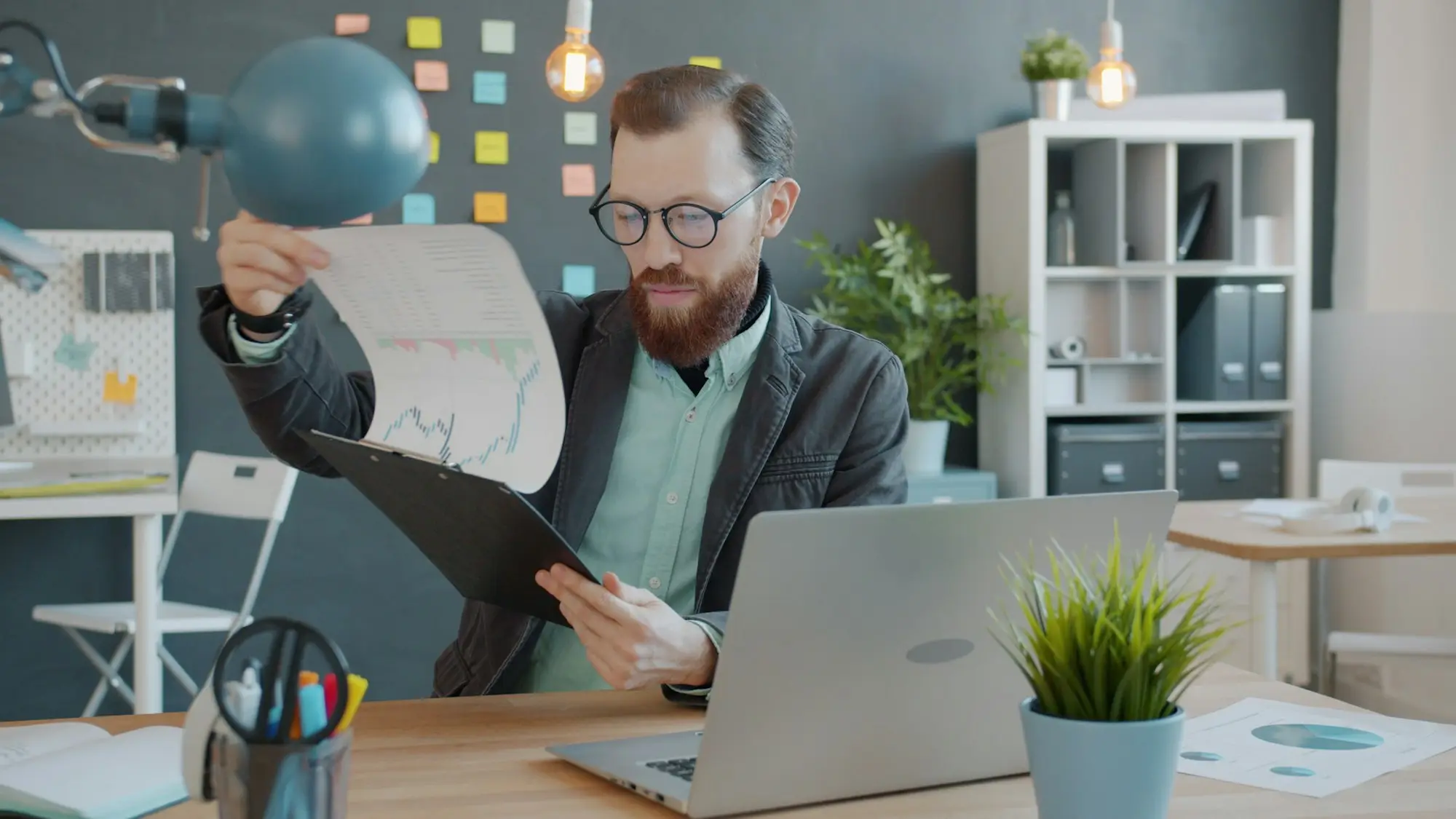 Man comparing documents at his office desk